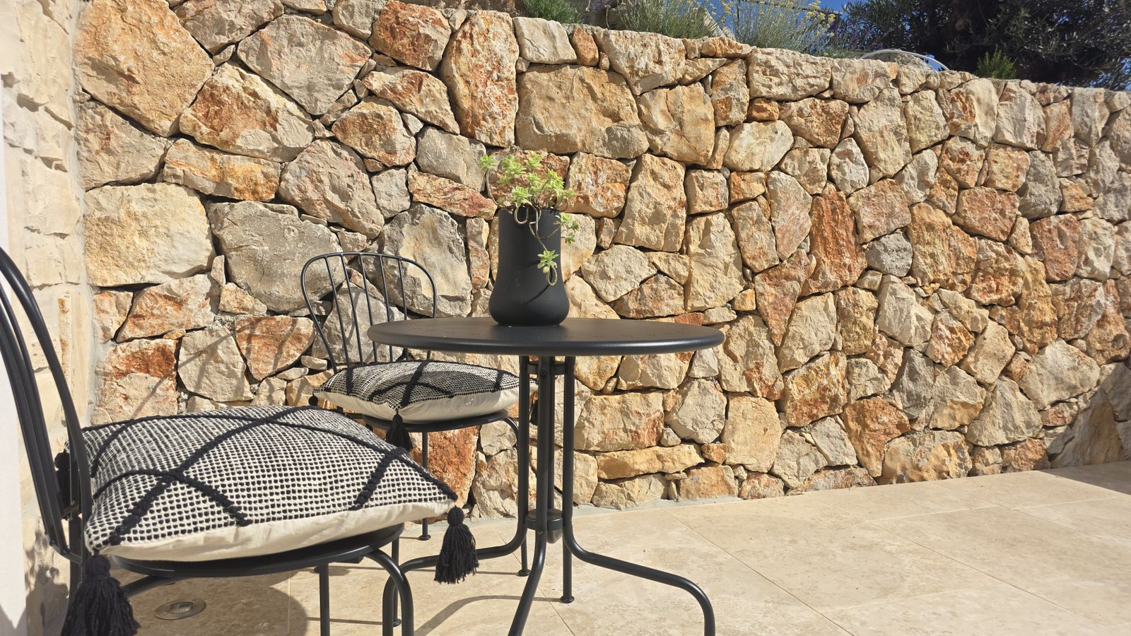 Bistro table on the stone terrace at Villa Casa Bacchus