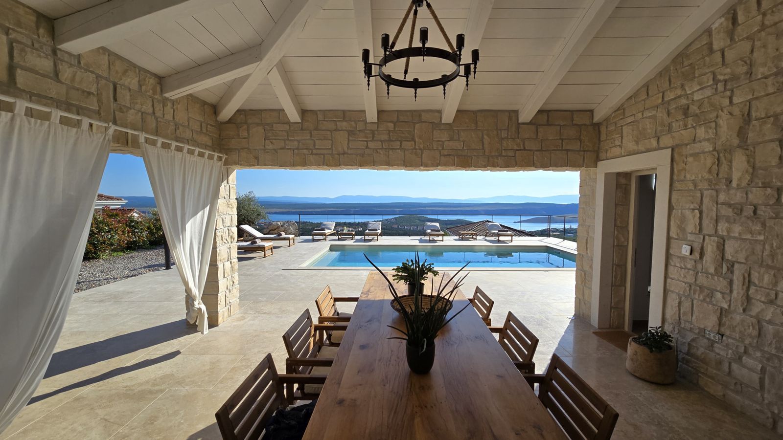 Shaded dining by the pool at Villa Casa Bacchus